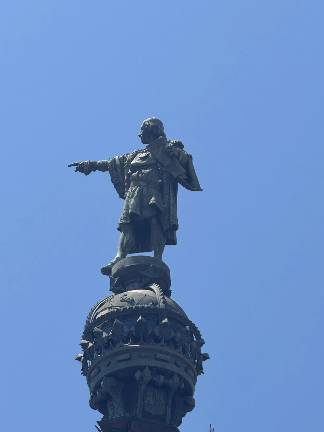Looking up at the monument against a blue sky.